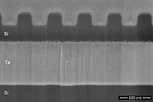 Focused ion beam cross-section through a silicon grating on top of a tantalum interlayer on top of silicon substrate.